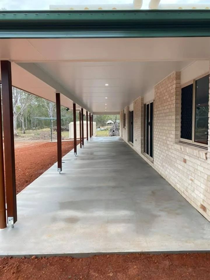 Long, Covered Concrete Porch with Brown Support Beams — Country to Coast Homes In Gregory River, QLD