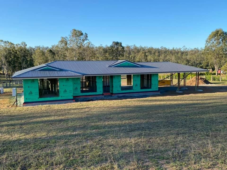 A Partially-Built House with A Metal Roof and Green Sheathing — Country to Coast Homes In Gregory River, QLD