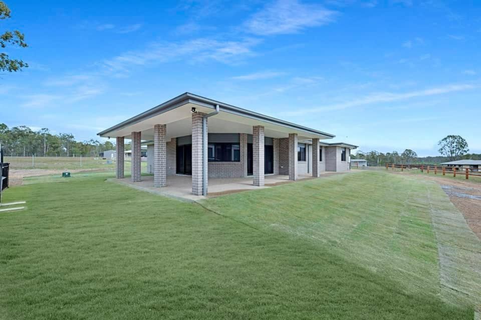 A Single-Story House with A Covered Porch Supported by Columns — Country to Coast Homes In Gregory River, QLD