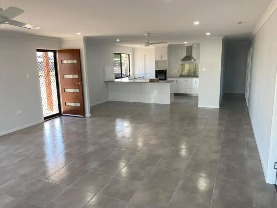 Open-Plan Living Space with Light Gray Tile Floors, White Walls — Country to Coast Homes In Gregory River, QLD