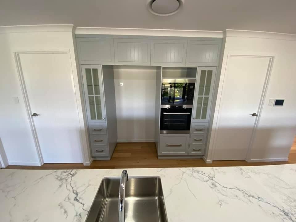 A Modern Kitchen with A White Countertop, Stainless Steel Sink — Country to Coast Homes In Gregory River, QLD