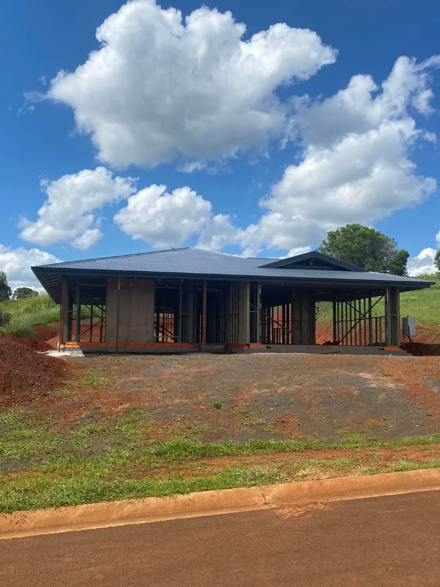 A Partially Constructed Building with A Blue Roof — Country to Coast Homes In Gregory River, QLD