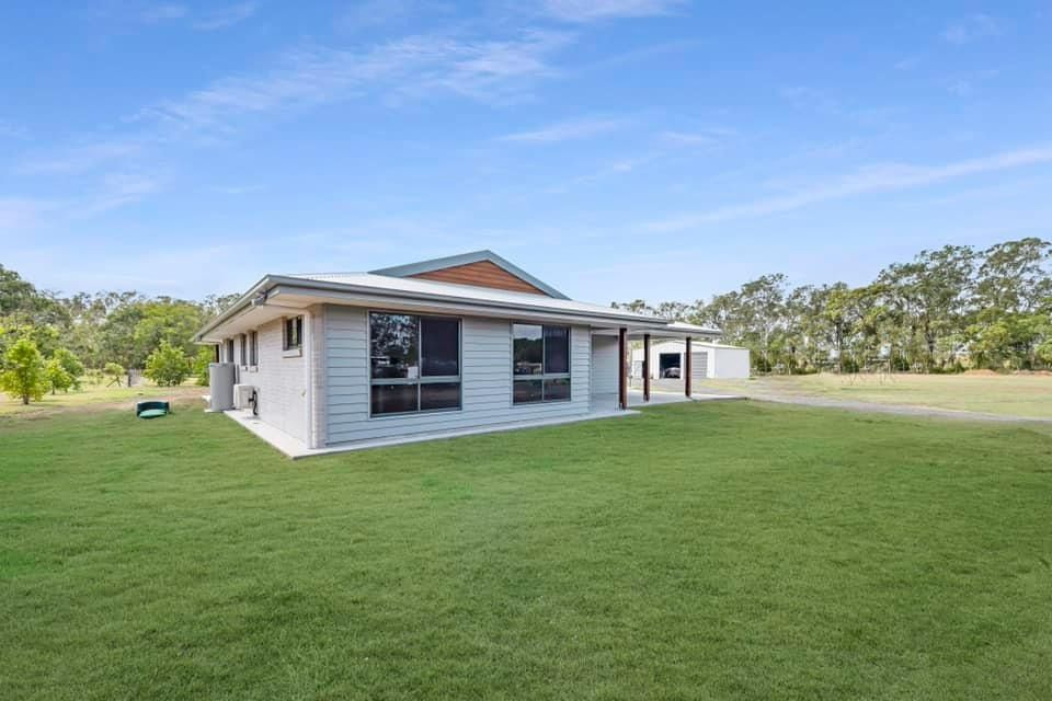 A Light Gray House with Dark-Framed Windows and A Small Covered Porch — Country to Coast Homes In Gregory River, QLD