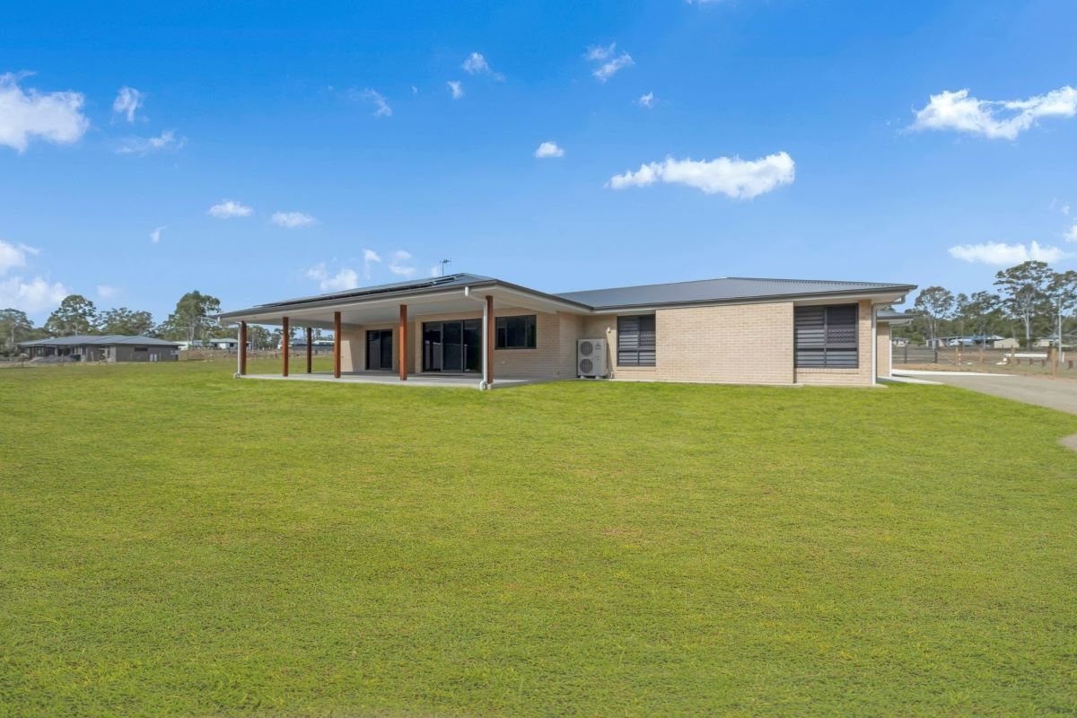 A Single-Story Brick Home with A Covered Patio — Country to Coast Homes In Gregory River, QLD