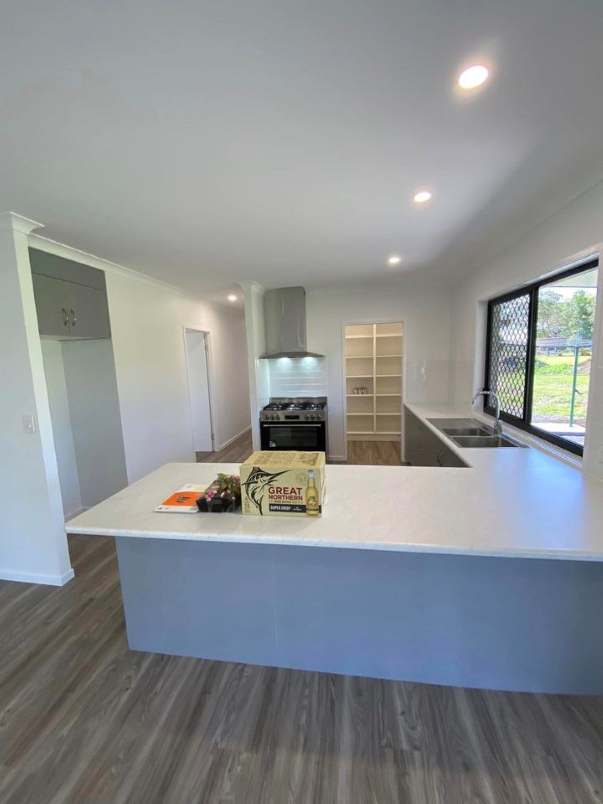 Modern Kitchen with Gray Island, White Countertops — Country to Coast Homes In Bundaberg, QLD