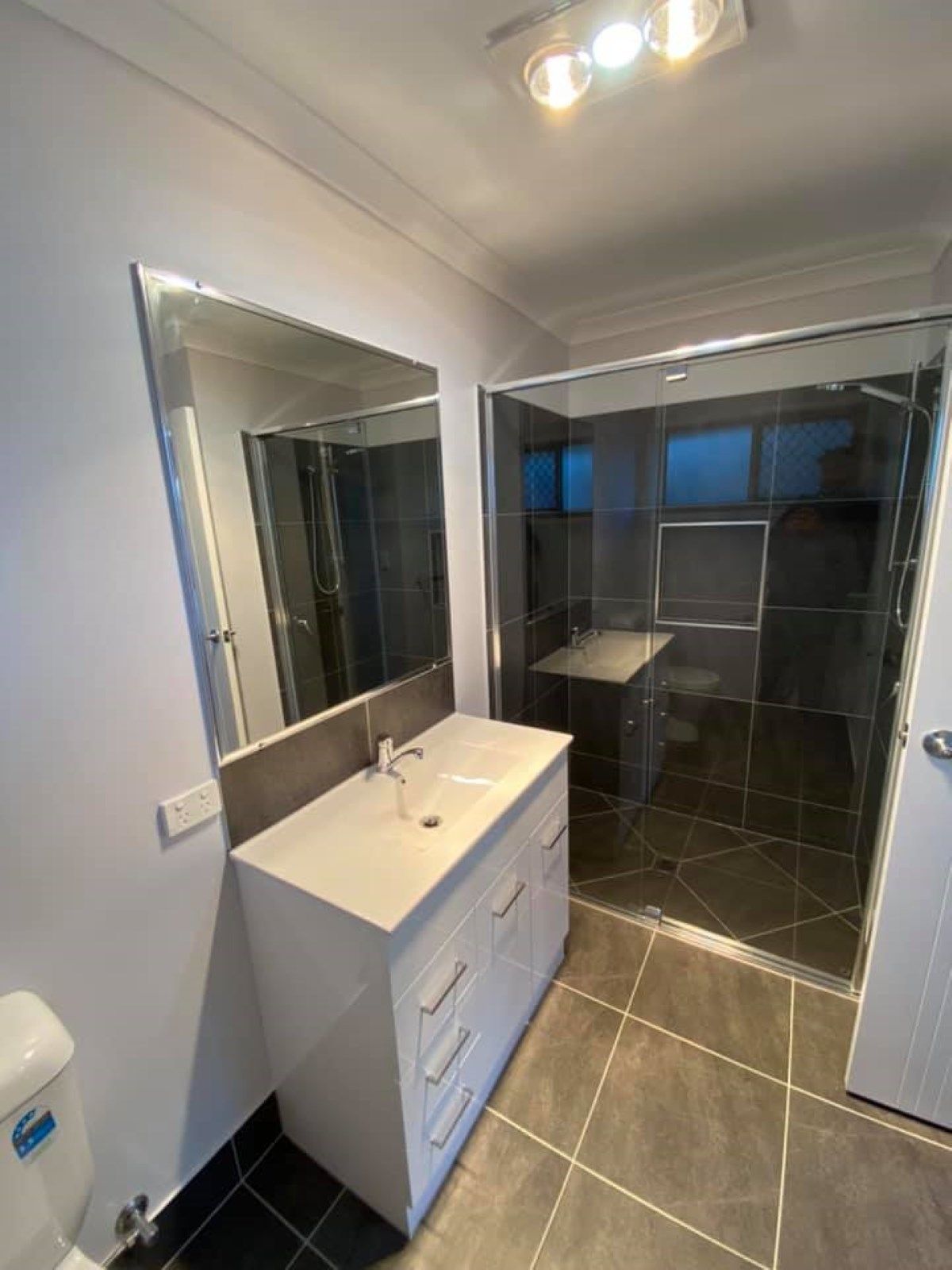Bathroom with A White Vanity, Large Mirror, Glass Shower — Country to Coast Homes In Woodgate, QLD