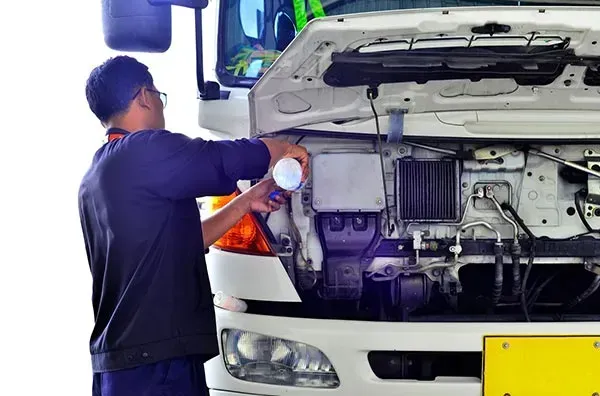 A Man Is Working on The Engine of A Truck — Wyong Radiator Repairs in Tuggerah, NSW