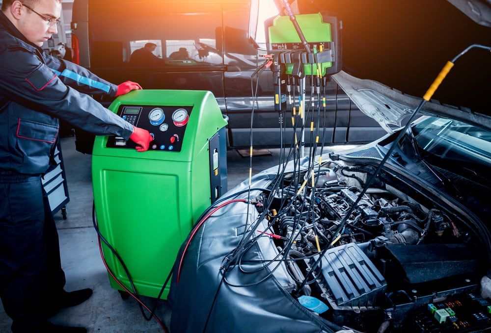 A Man Is Working on A Car in A Garage — Wyong Radiator Repairs in Tuggerah, NSW