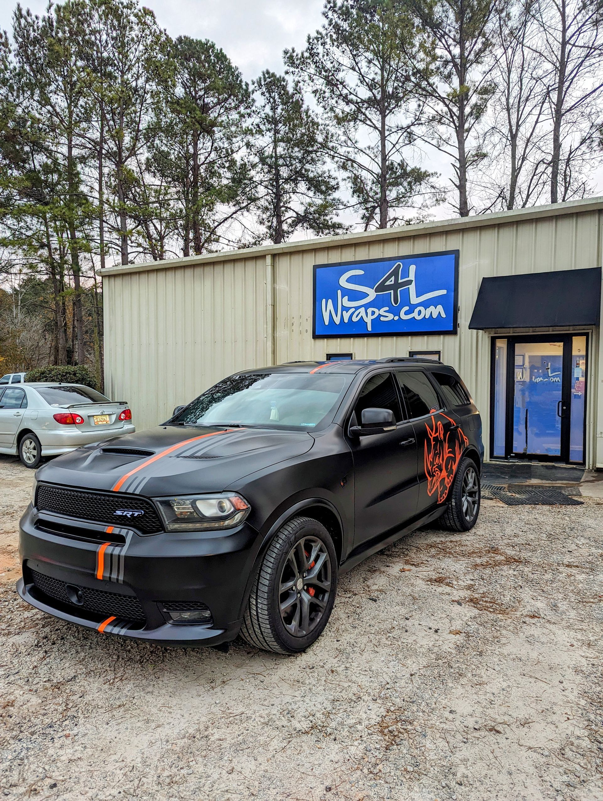 full black color change wrap with orange stripes and rhino graphic
