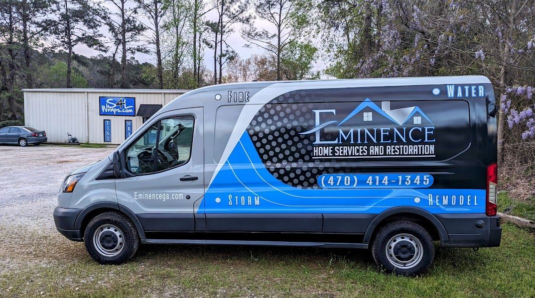 custom full printed commercial wrap in gray with black, white and blue graphics and logos