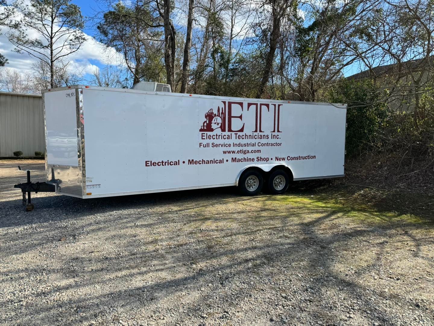 red cut vinyl logos and lettering on white trailer