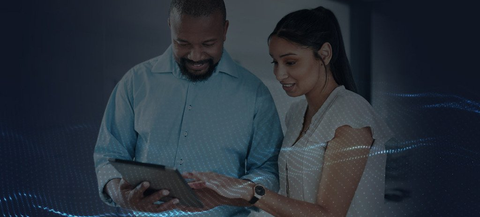 Two people looking at an ipad