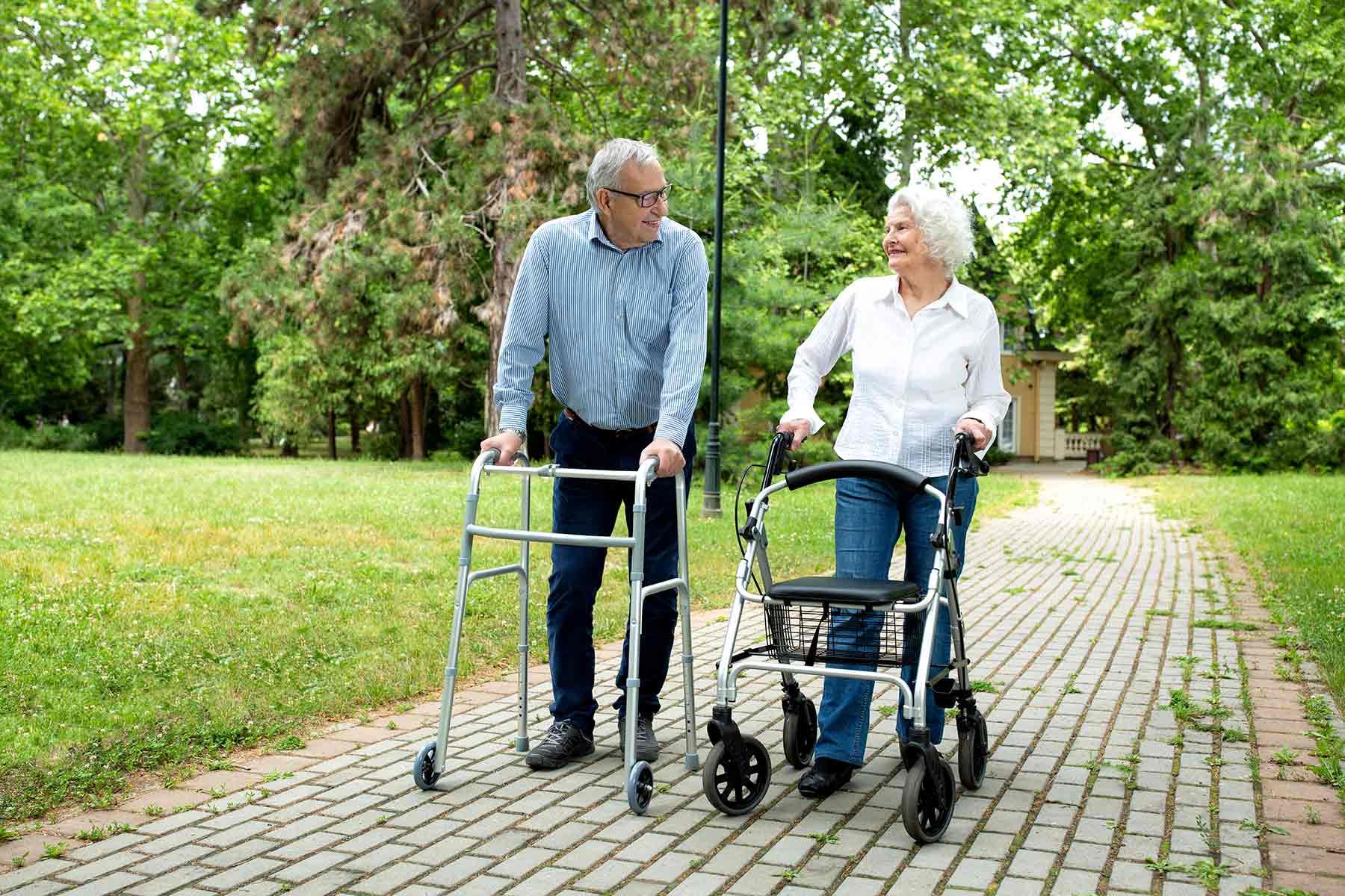 A Woman And A Man With Walkers — Mobility Modification Services In Garbutt, QLD