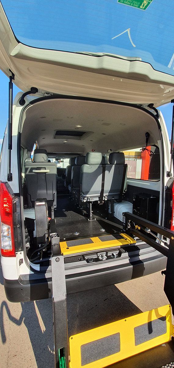 The Back of A Van with The Door Open and A Wheelchair in The Back — Mobility Modification Services In Garbutt, QLD