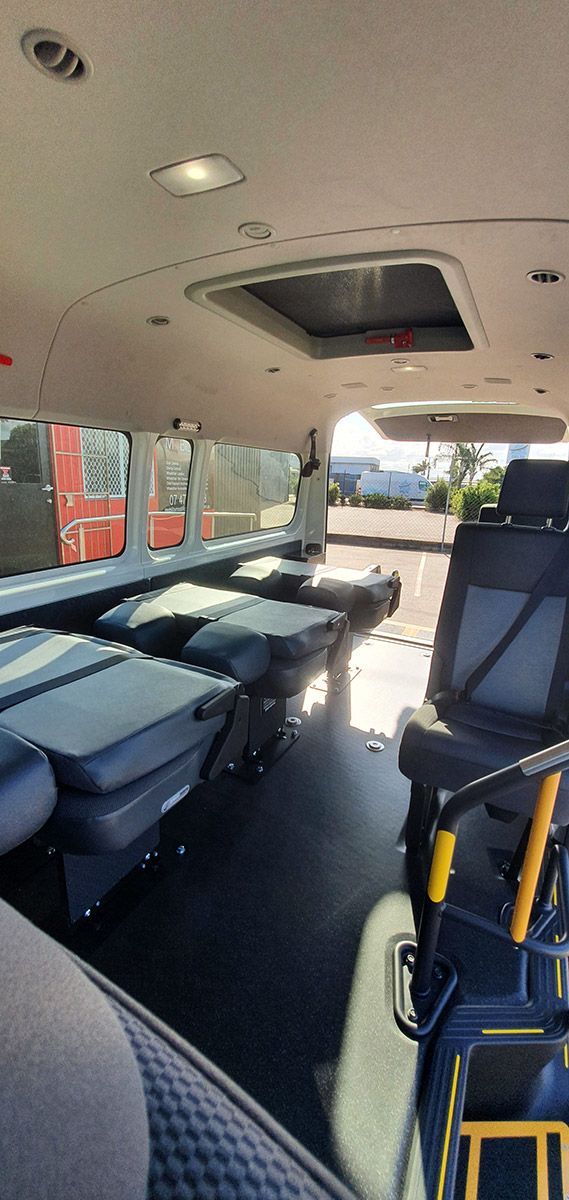 The Inside of A Van with Tables and Chairs — Mobility Modification Services In Garbutt, QLD