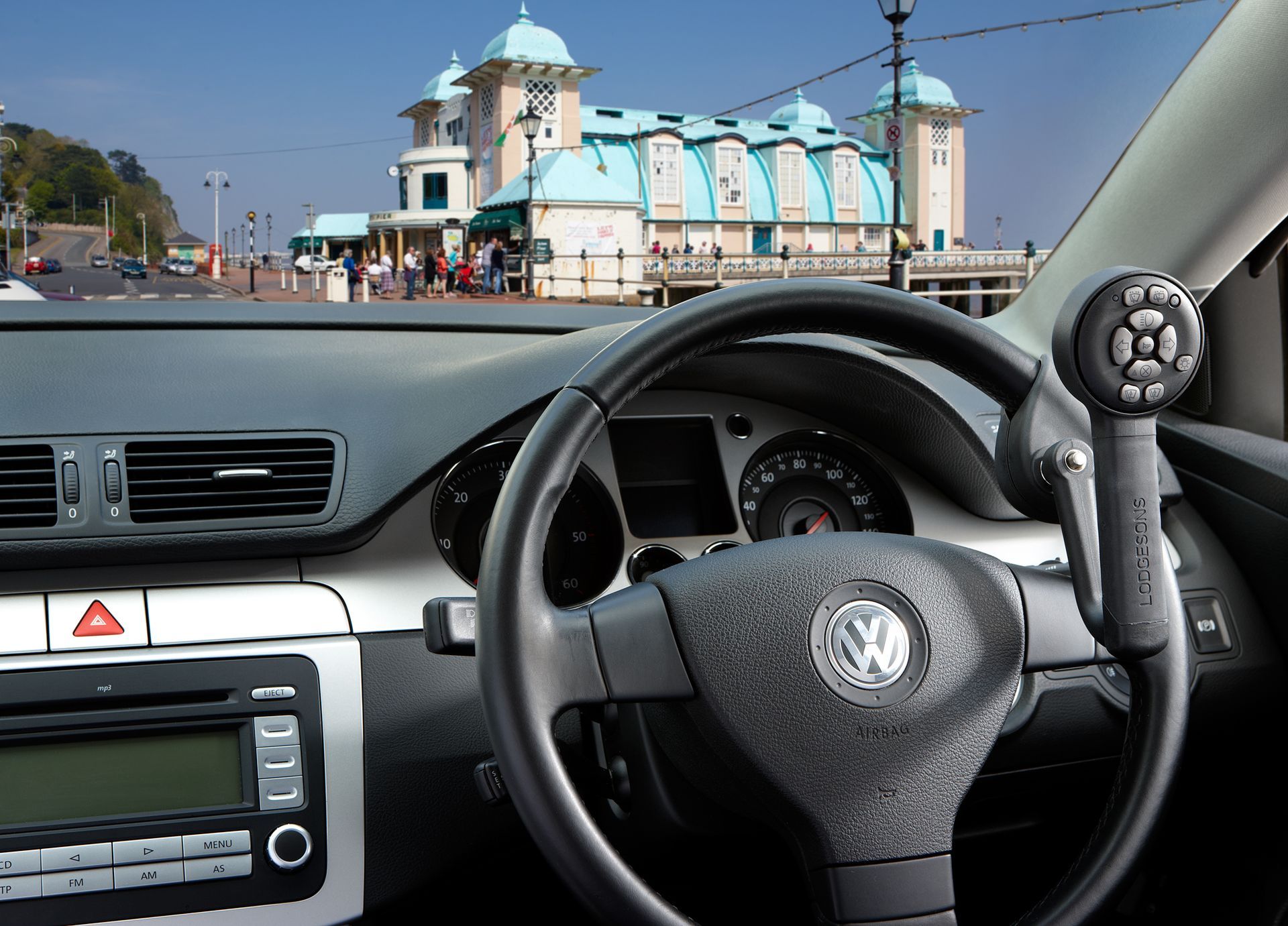 A Man in A Suit Is Driving a Car — Mobility Modification Services In Garbutt, QLD