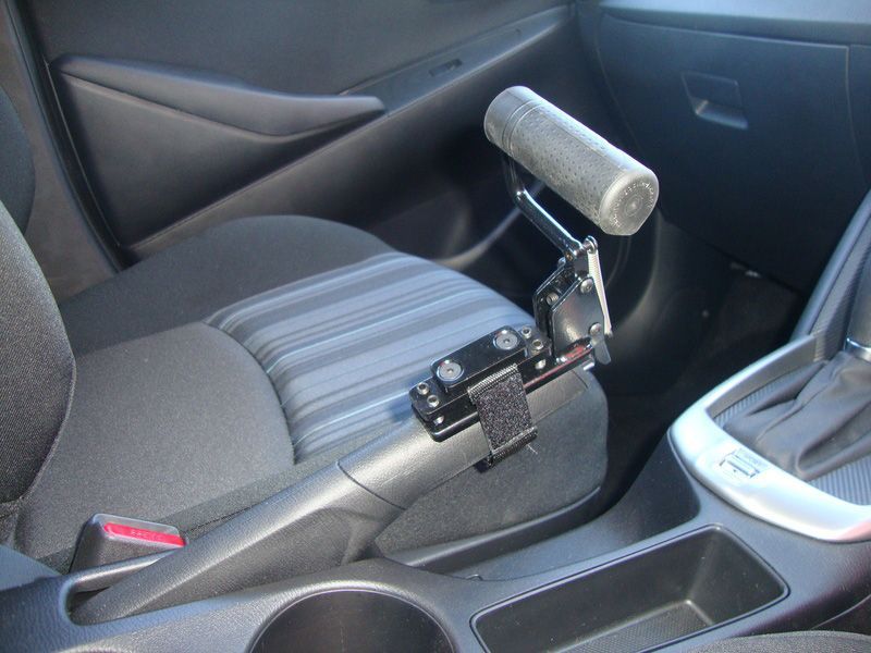 A Car with A Hand Brake Attached to The Seat — Mobility Modification Services In Garbutt, QLD