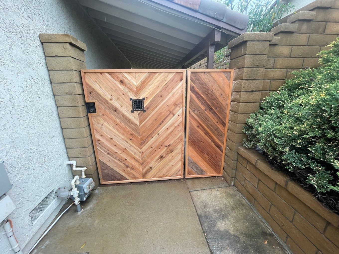A wooden gate with a herringbone pattern on it