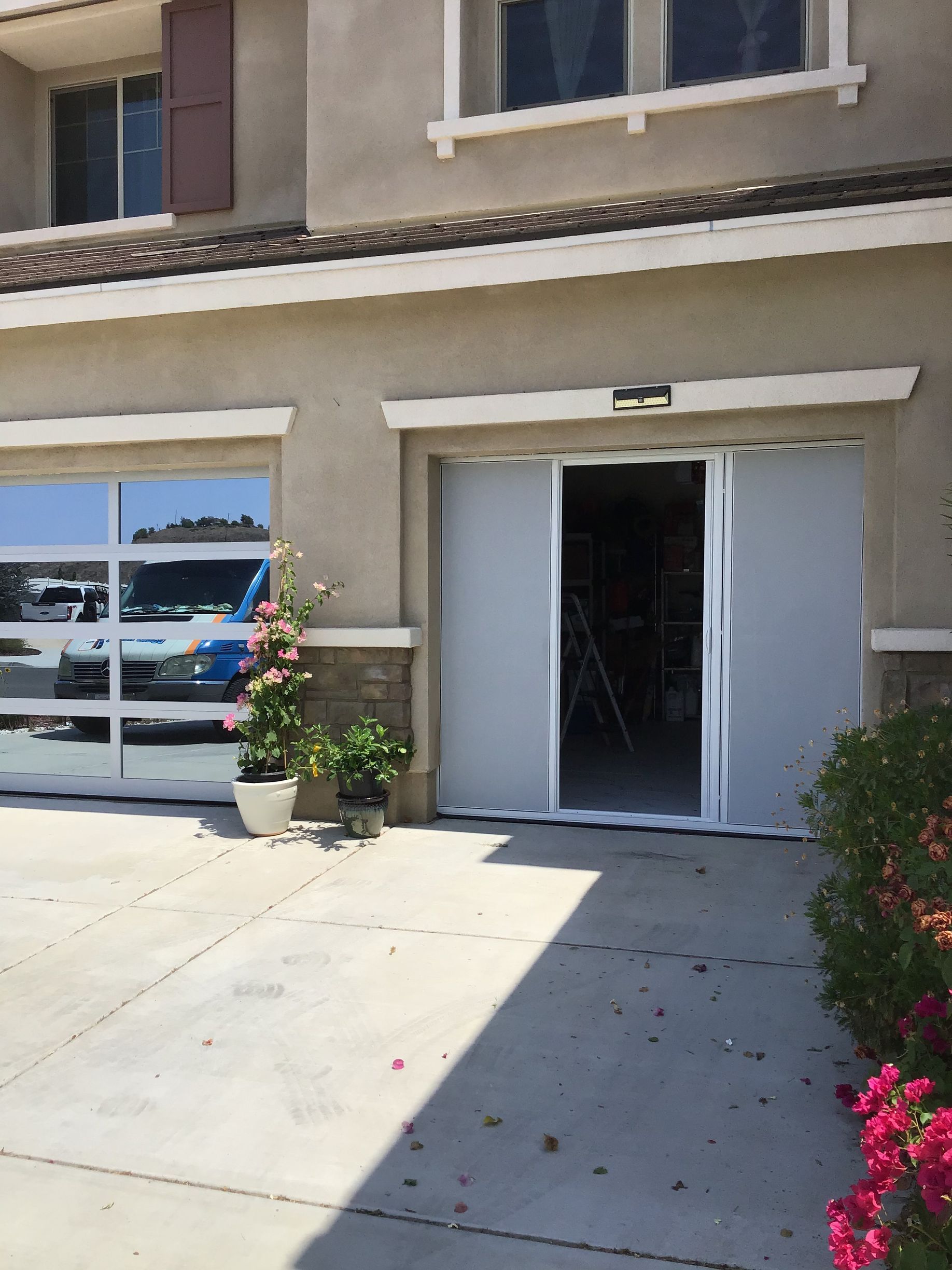 A house with a garage door that is open