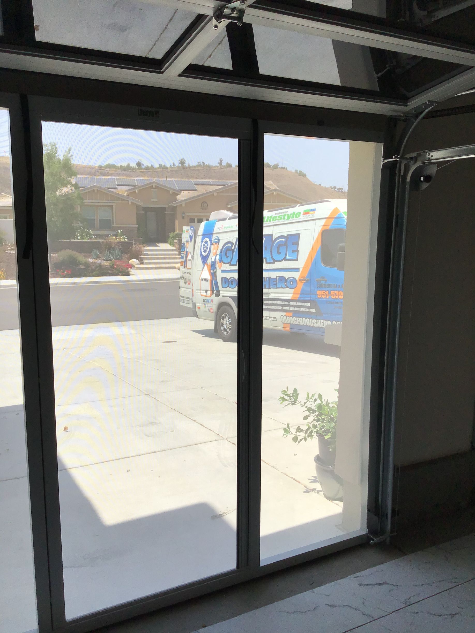 A van is parked in front of a garage door.