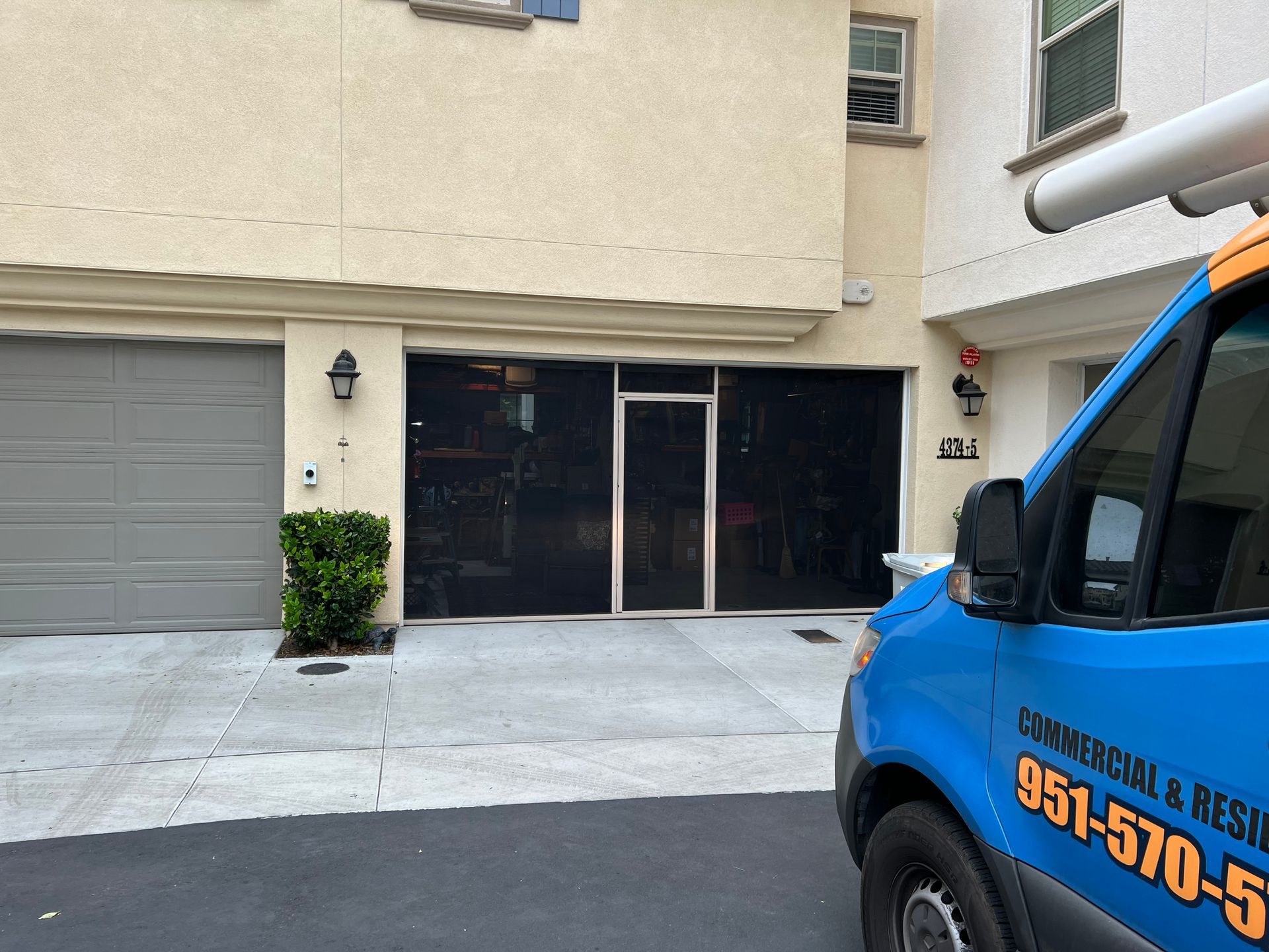 A blue van is parked in front of a building.