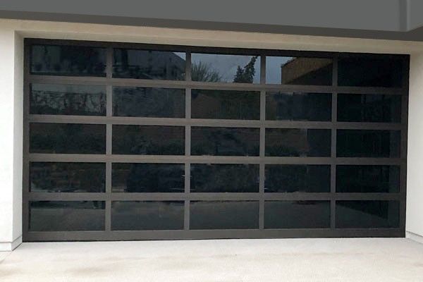A garage door with a lot of windows and a black frame.