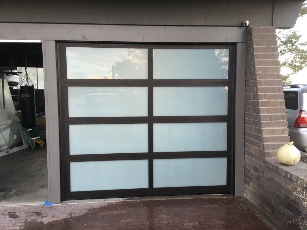 A car is parked in front of a garage door