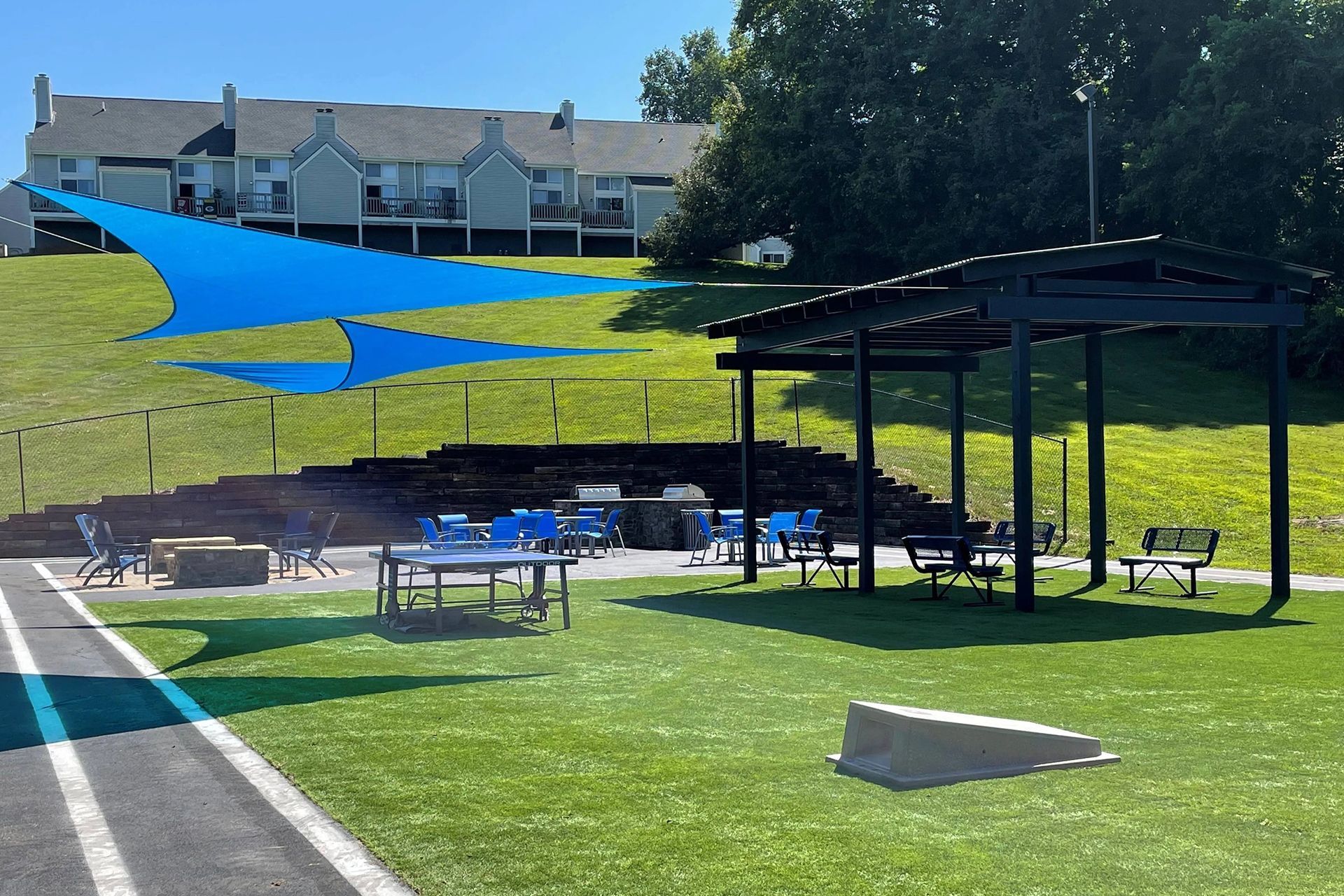 Park area with blue shade sails, pergola, tables, and benches at Sterling Hills in Johnson City, TN.