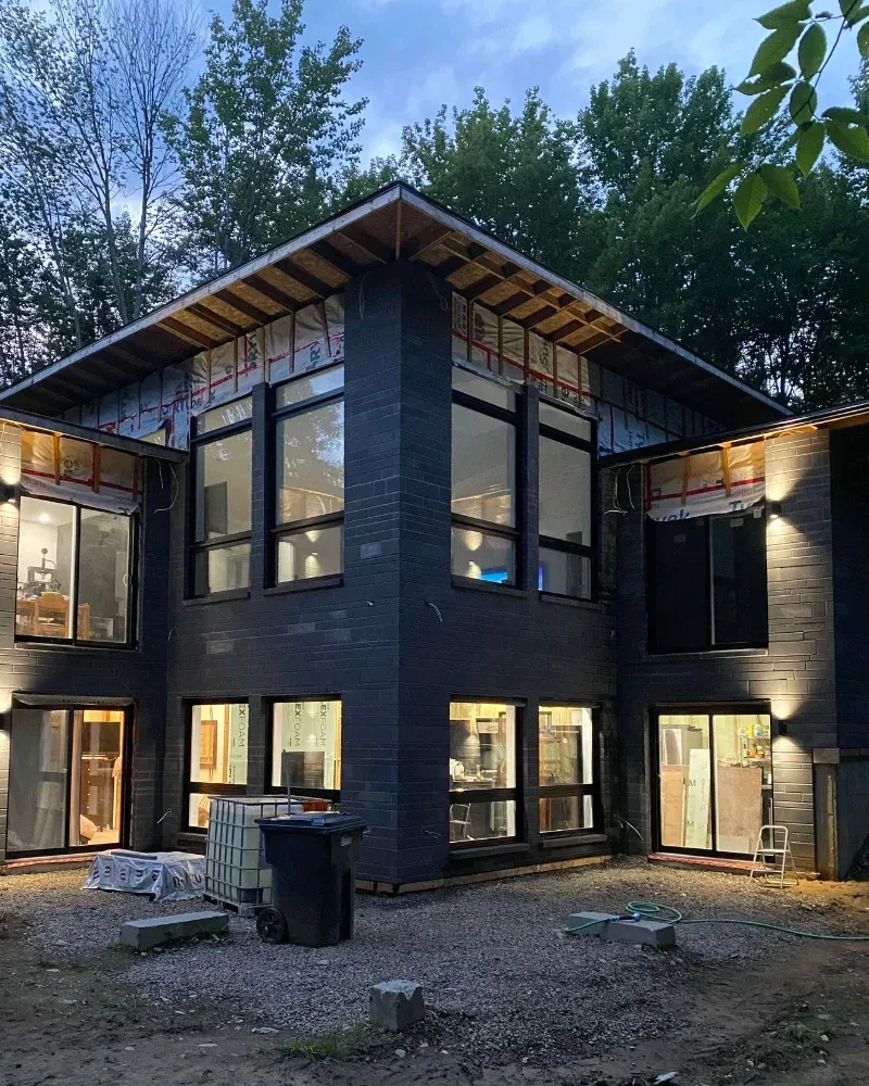 Une grande maison avec beaucoup de fenêtres est en construction
