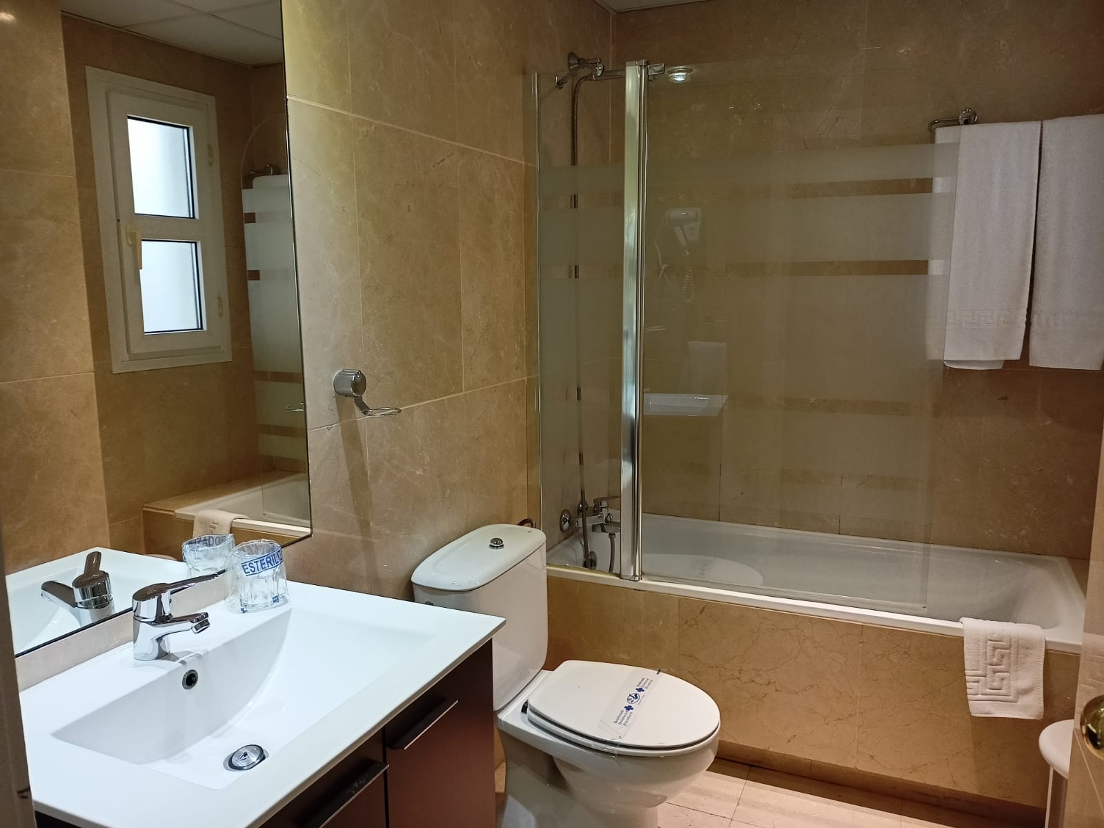 Un cuarto de baño con inodoro, lavabo y bañera.