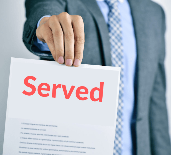 Person in a suit holding a document labeled 