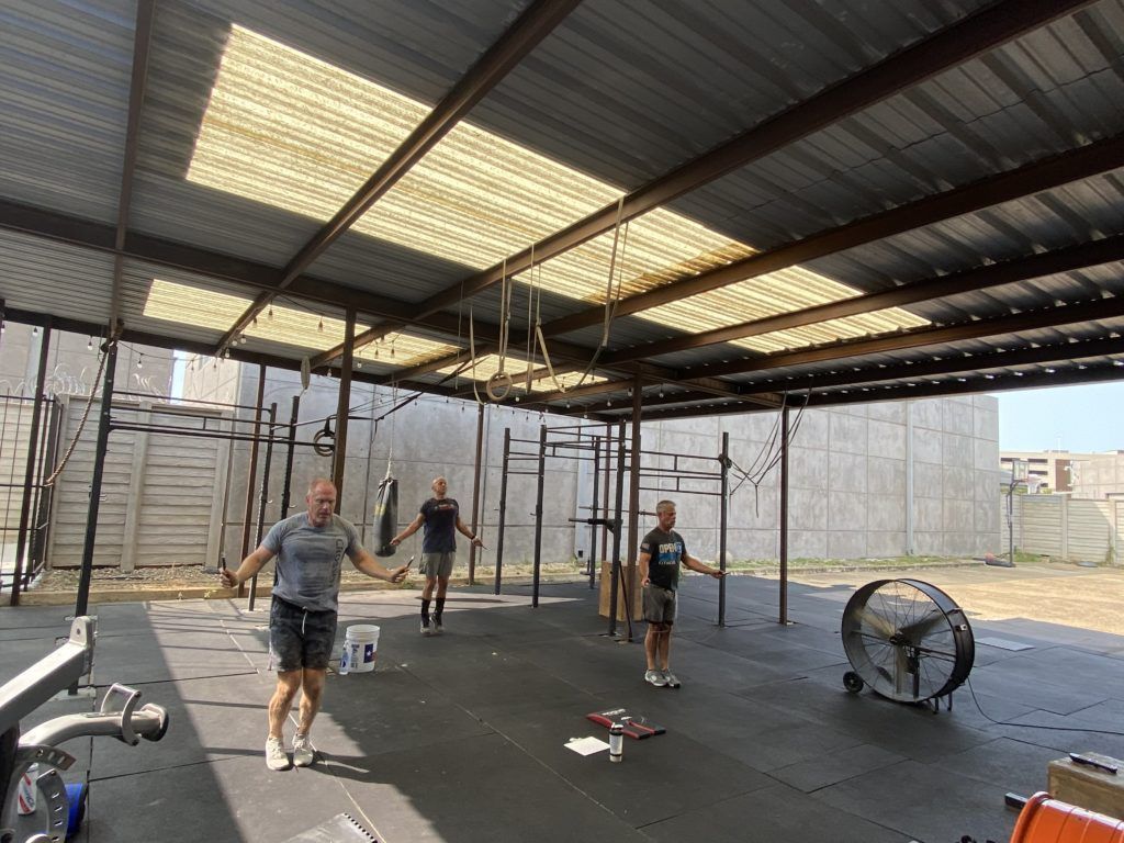 A group of people are jumping rope in a gym.
