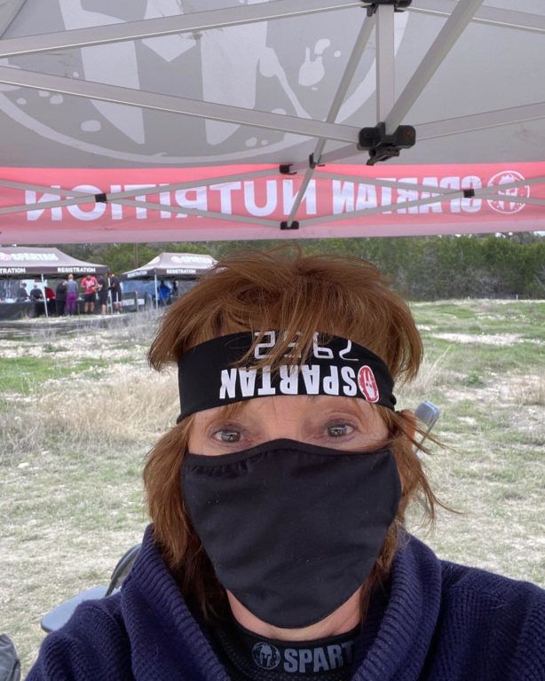 A woman wearing a headband that says spartan on it