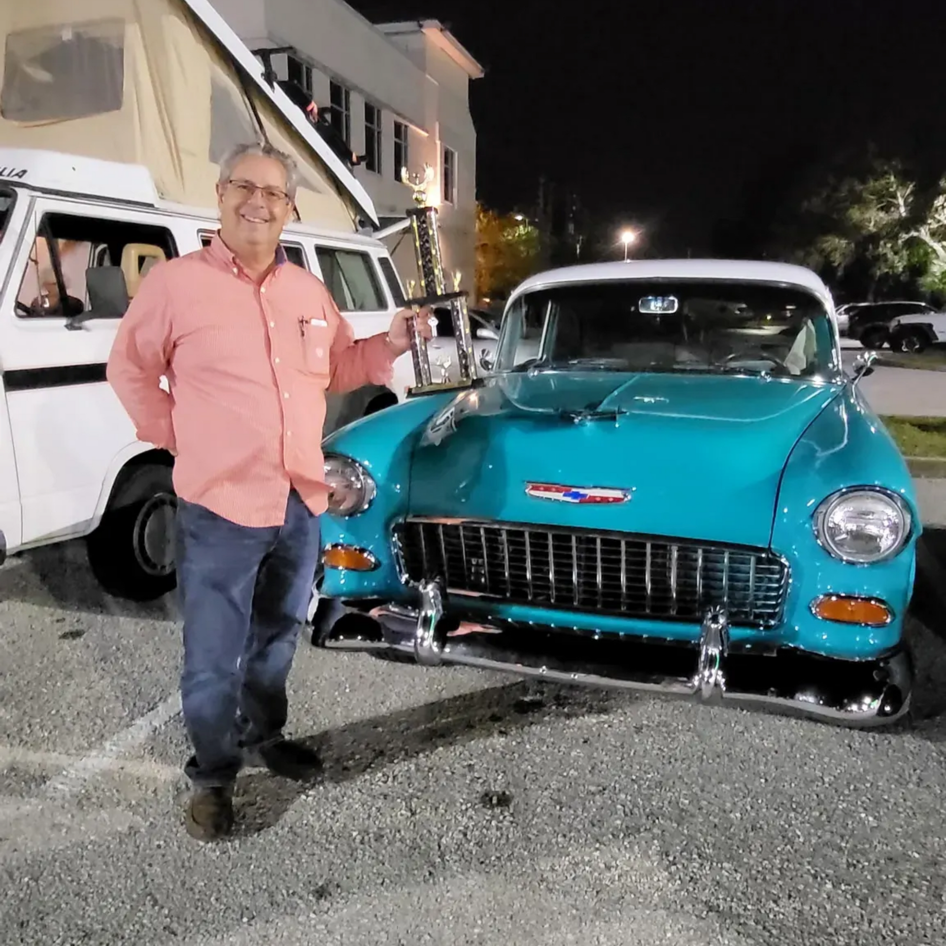 Owner-standing-in-front-of-award-winning-vehicle-with-trophy-after-paint-correction-and-ceramic-coat