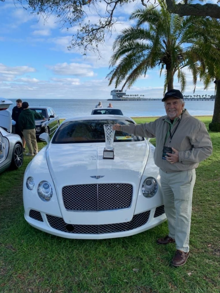 Owner+standing+in+front+of+award winning+vehicle+with+trophy after ceramic coating installation by Steve Calafato