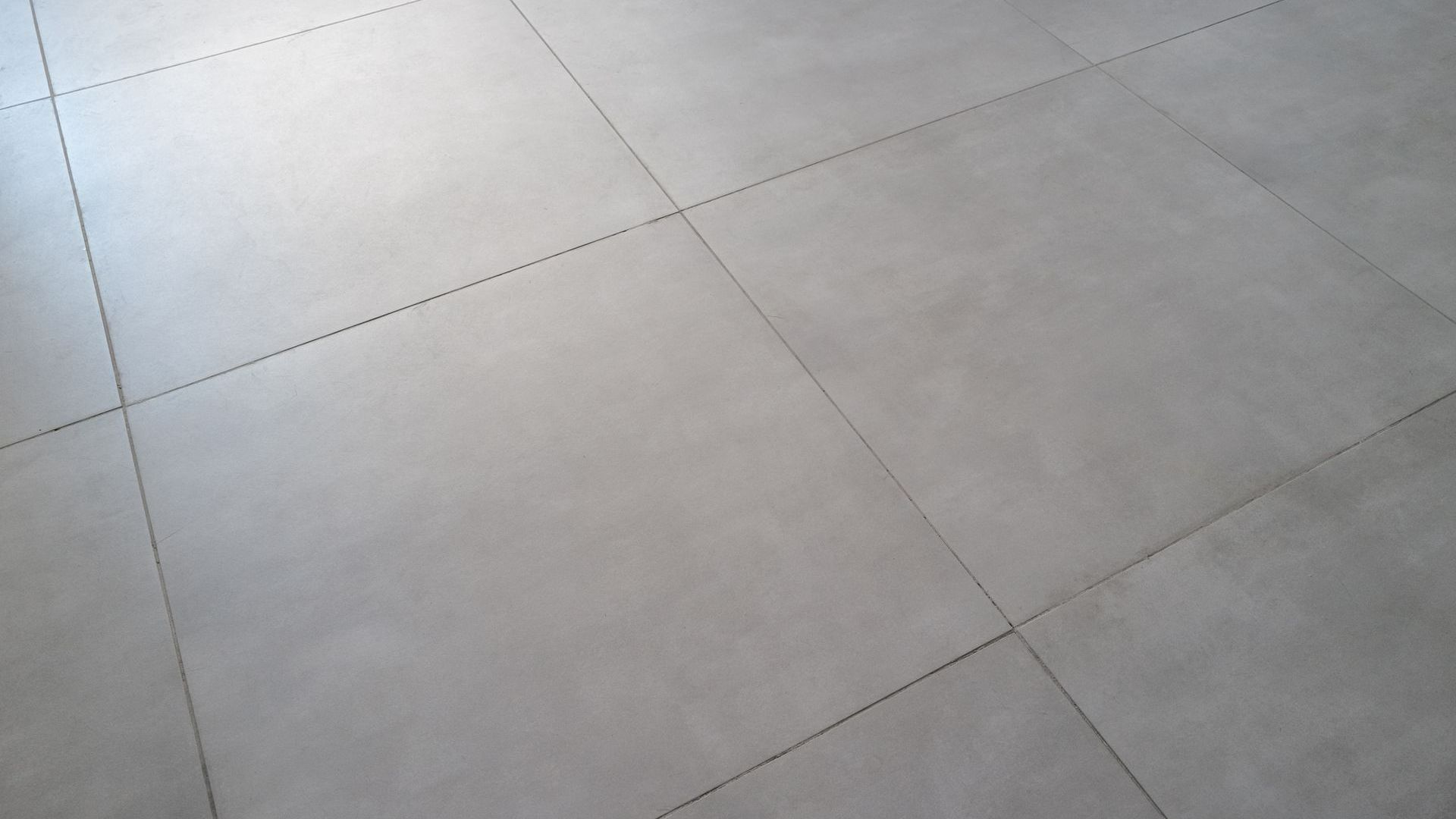 Gray tiled floor with dark grout lines.