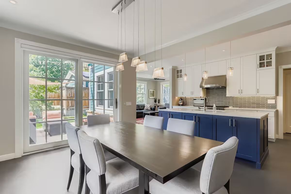 bright kitchen windows and blue cabinets