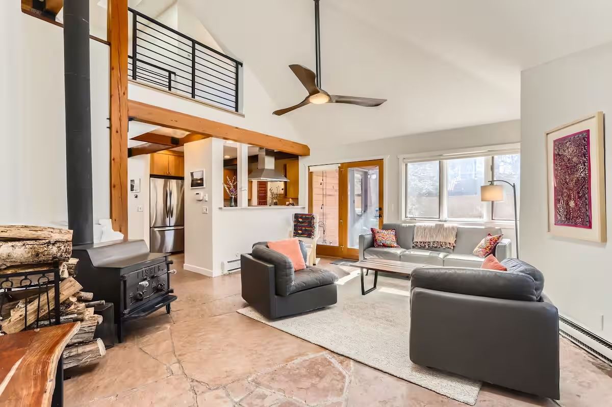 wood stove big bright living room with loft and modern fan
