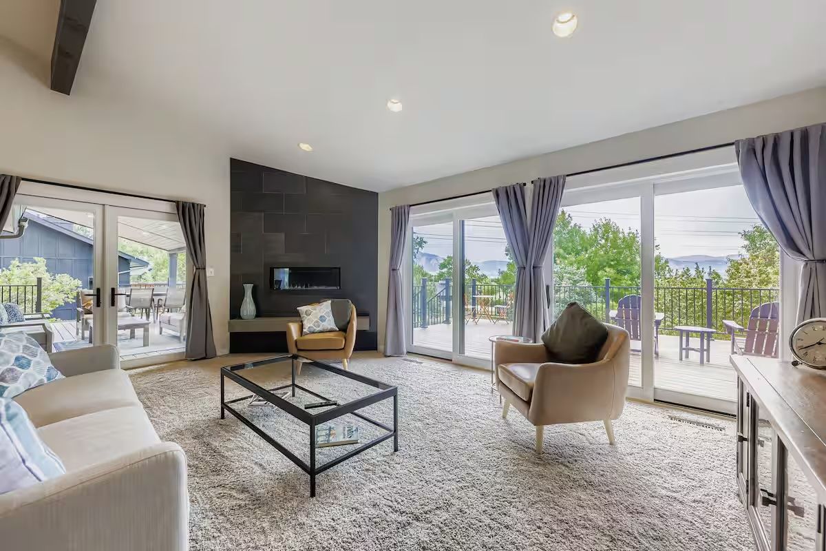 bright living room with curtains and 3 windows