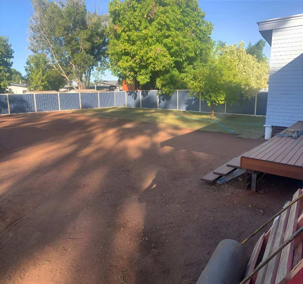 The Backyard Landscape Of A House With A Deck And A Fence — NQES Industries in Ryan, QLD