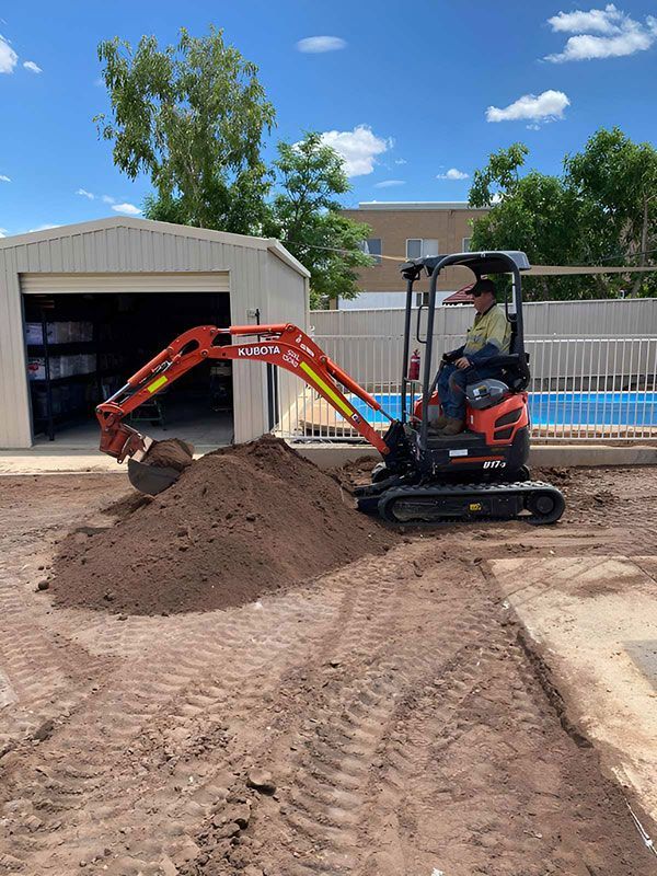 A Man Is Driving And Working Small — NQES Industries in Ryan, QLD