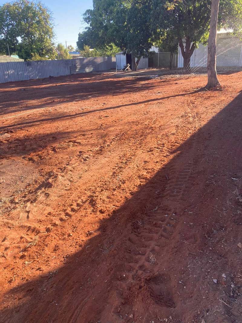A Dirt Field With Trees And A Fence In The Background — NQES Industries in Ryan, QLD