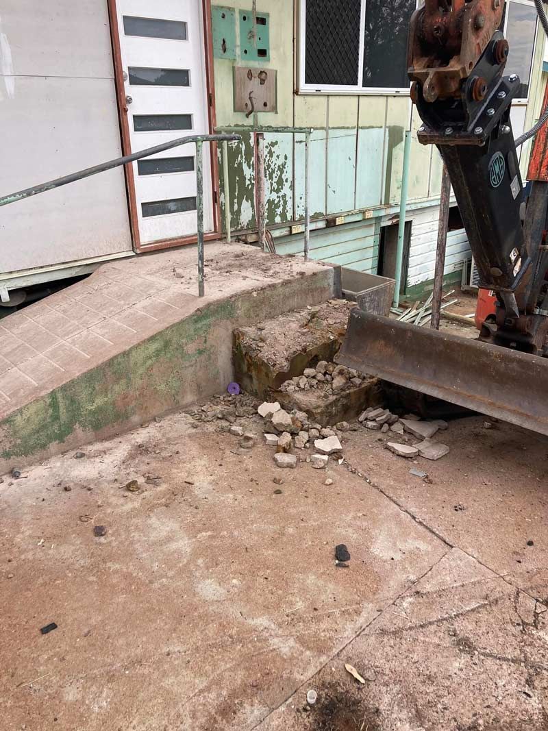 A Bulldozer Is Being Used To Remove A Ramp From A Building — NQES Industries in Tennant Creek, NT