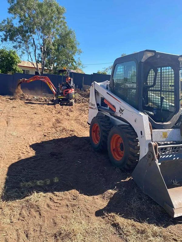 Bobcat Loader Equipment And Orange Excavator — NQES Industries in Ryan, QLD