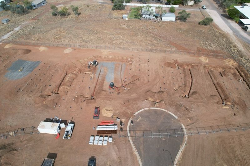 An aerial view of a dirt field with a light bulb in the middle — NQES Industries in Ryan, QLD