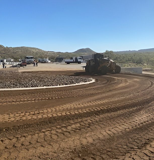 A Bulldozer Is Working On A Large Dirt Road — NQES Industries in Ryan, QLD