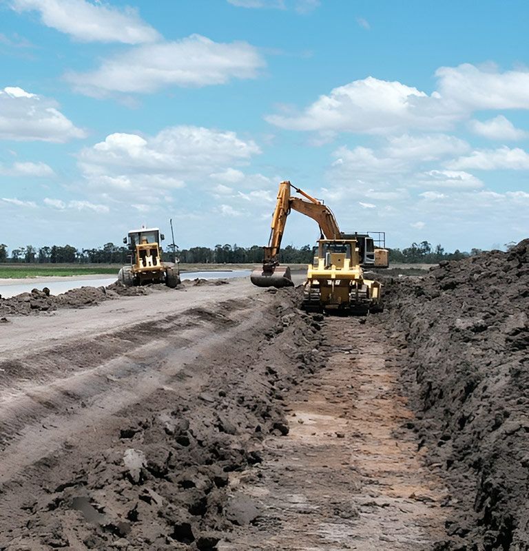 A couple of construction equipment Working In The Large Construction Site — NQES Industries in Ryan, QLD