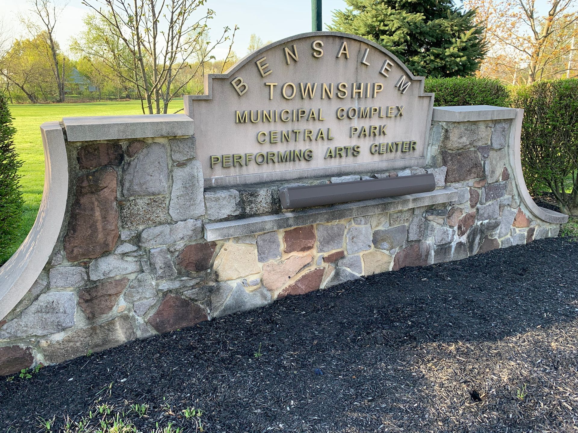 Sign for Bensalem Township Municipal Complex, Central Park, and Performing Arts Center. Stone and concrete structure.