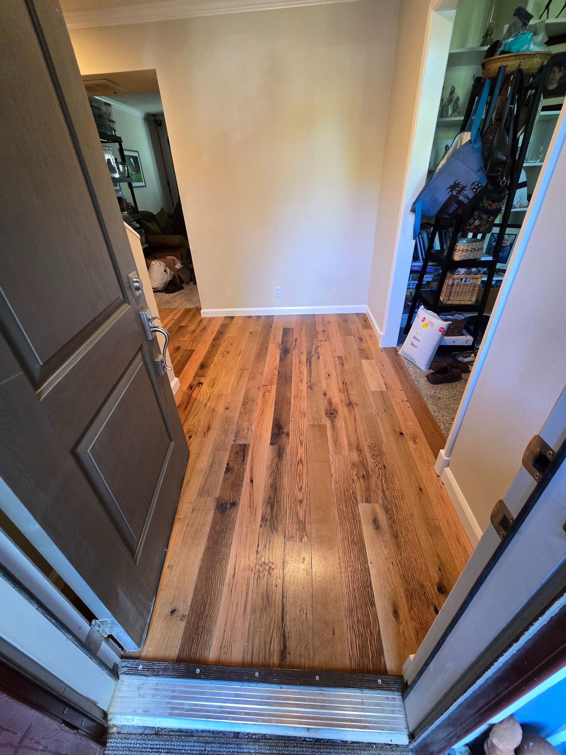 Transformed Davis, CA home by replacing dated Saltillo tile with beautiful, eco-friendly reclaimed hardwood floors.