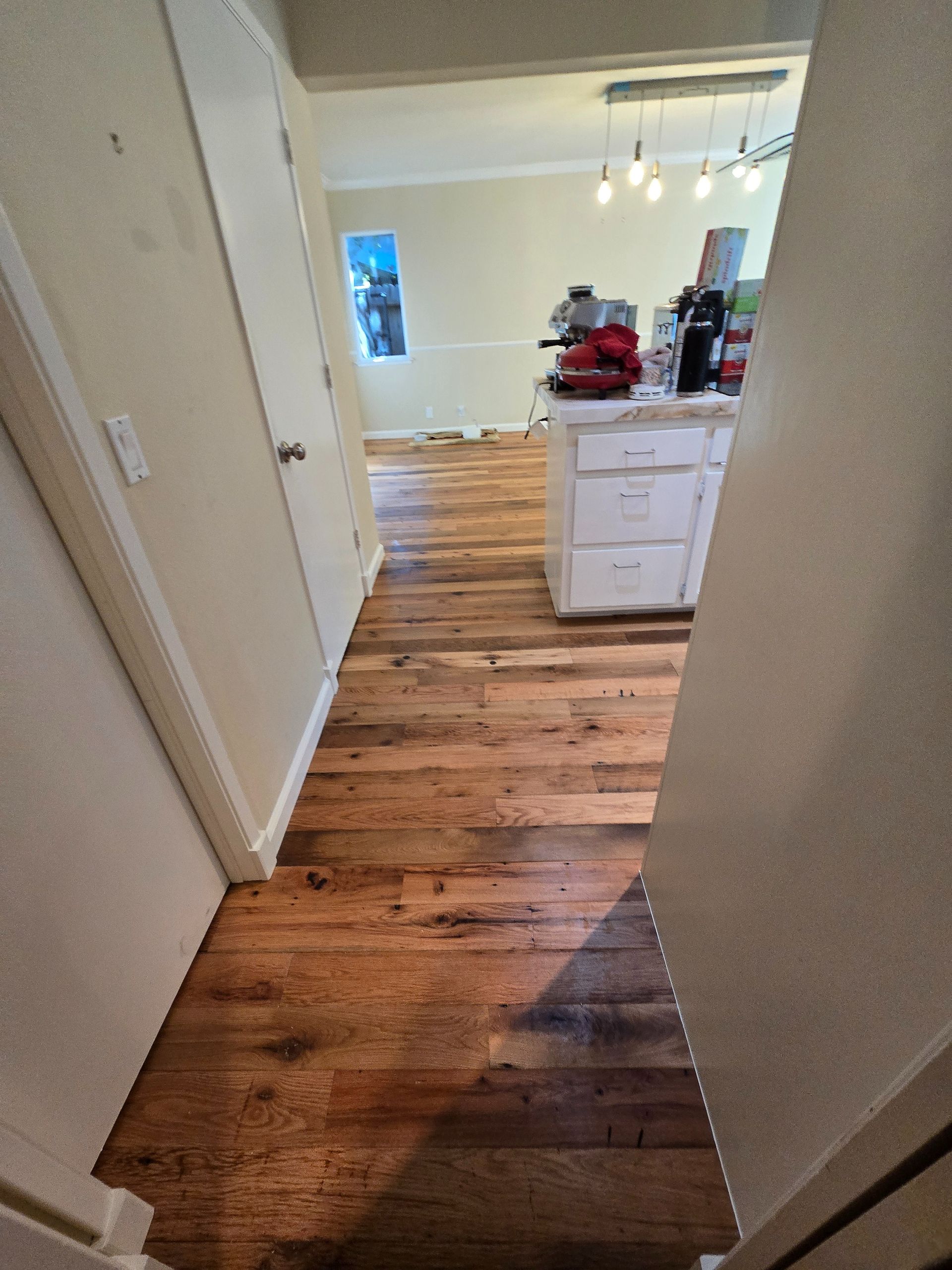 Transformed Davis, CA home by replacing dated Saltillo tile with beautiful, eco-friendly reclaimed hardwood floors.